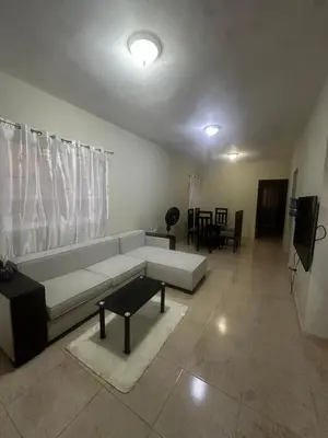 a living room with a white couch and a tv at Espacioso Casa en Puerto Plata cerca de La Playa 4 camas 3 baños Agua caliente Aire condicionado Wi-Fi in Puerto Plata