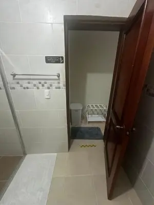 a bathroom with a shower with a door open at Espacioso Casa en Puerto Plata cerca de La Playa 4 camas 3 baños Agua caliente Aire condicionado Wi-Fi in Puerto Plata