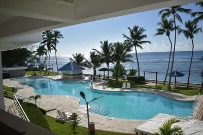 a swimming pool with the ocean in the background at El Sueño, Breathtaking Ocean Front, Juan Dolio in Guayacanes