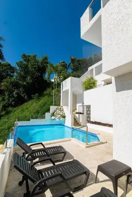 a villa with a swimming pool and some chairs at Casa Mango- Relax - Pool Stunning Views in San Felipe de Puerto Plata