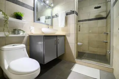 a bathroom with a toilet and a sink and a shower at Casa Mango- Relax - Pool Stunning Views in San Felipe de Puerto Plata