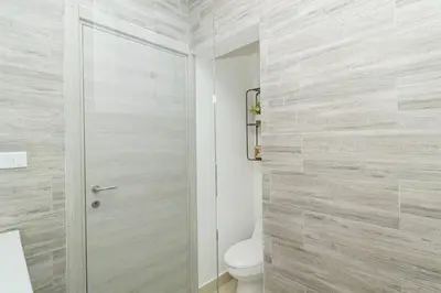 a bathroom with a toilet and a glass shower door at Coastal Comfort in Bayahibe 2BR 2BA Carribean Rose in San Rafael del Yuma