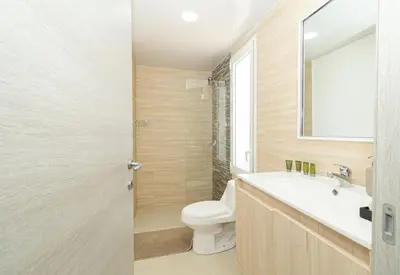 a bathroom with a toilet and a sink and a mirror at Coastal Comfort in Bayahibe 2BR 2BA Carribean Rose in San Rafael del Yuma