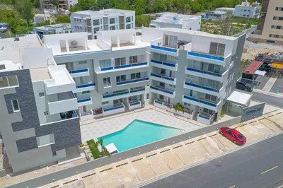 an aerial view of a building with a swimming pool at Coastal Comfort in Bayahibe 2BR 2BA Carribean Rose in San Rafael del Yuma