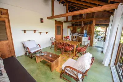 a living room with a table and chairs at Clave Verde Ecolodge in Las Terrenas