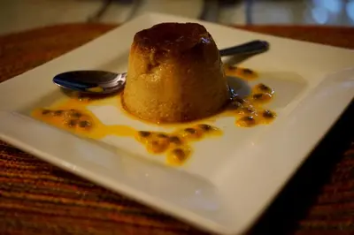 a piece of cake on a plate with a spoon at Clave Verde Ecolodge in Las Terrenas