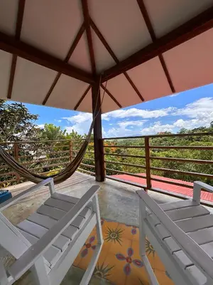 a room with two beds and a hammock at Clave Verde Ecolodge in Las Terrenas