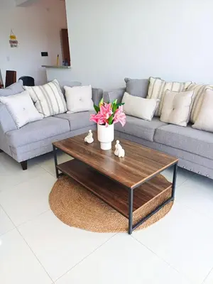 a living room with a couch and a coffee table at Sunrise Apartments in San Felipe de Puerto Plata