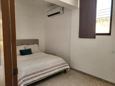 a small bedroom with a bed and a window at Apartment in Zona Colonial in Santo Domingo