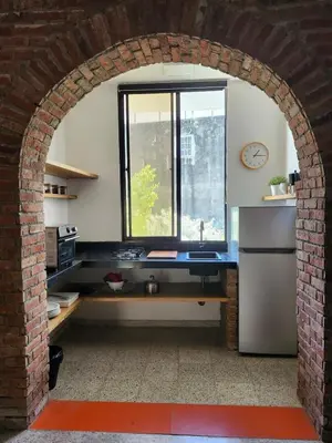 an archway in a kitchen with a refrigerator and a window at Apartment in Zona Colonial in Santo Domingo
