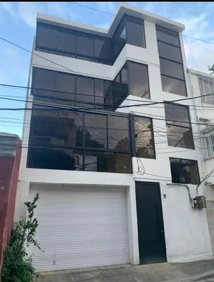 a tall white building with a lot of windows at Apartment in Zona Colonial in Santo Domingo