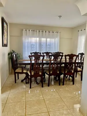 a dining room with a wooden table and chairs at Cheerfull 4 bedroom Villa with pool #VillaLioness in Nagua