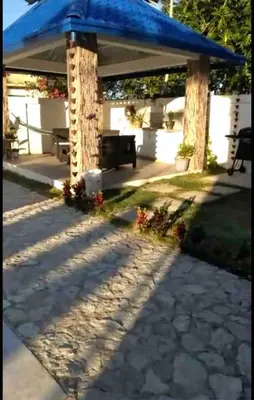 a blue gazebo with a bench in a yard at Cheerfull 4 bedroom Villa with pool #VillaLioness in Nagua