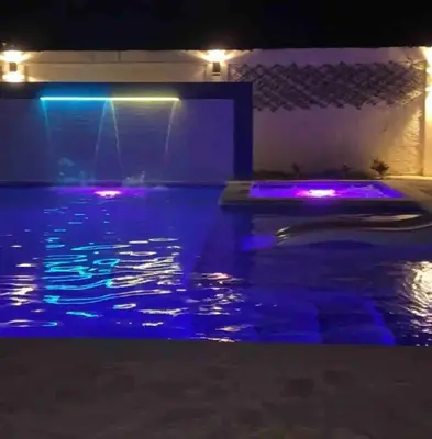a swimming pool at night with purple lights at Cheerfull 4 bedroom Villa with pool #VillaLioness in Nagua