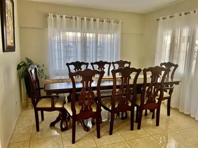 a dining room with a table and chairs and a window at Cheerfull 4 bedroom Villa with pool #VillaLioness in Nagua