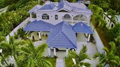 an aerial view of a house with a blue roof at Cheerfull 4 bedroom Villa with pool #VillaLioness in Nagua