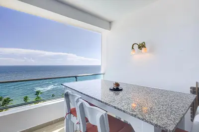 a kitchen with a view of the ocean at Apartamento Hermoso Frente Al Mar 11fl Amanzing in Juan Dolio