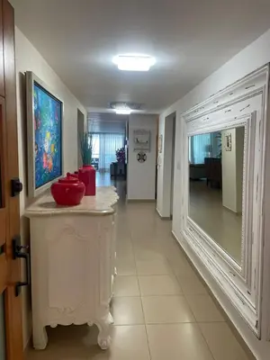 a room with a hallway with a red bowl on a counter at Luxury Penthhouse Frente Al Mar in Juan Dolio
