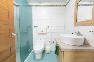 a bathroom with a toilet and a sink at Luxury Penthhouse Frente Al Mar in Juan Dolio