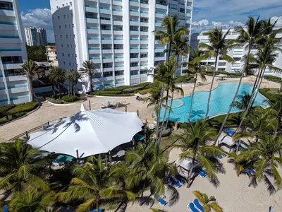 an aerial view of a resort with a pool and palm trees at Luxury Penthhouse Frente Al Mar in Juan Dolio