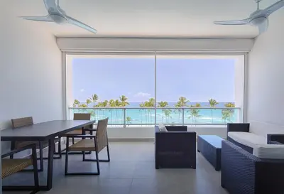a dining room with a table and a large window at Apartamento En Marbella Vista Al Mar in Villas del Mar