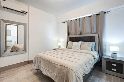 a bedroom with a large bed and a mirror at Coralclifftower in Juan Dolio