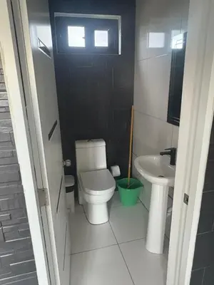 a small bathroom with a toilet and a sink at LEVEL suites in Sosúa