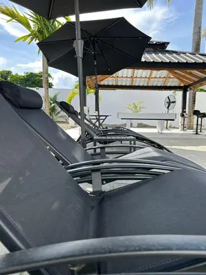 a pair of chairs and an umbrella on top of a car at LEVEL suites in Sosúa