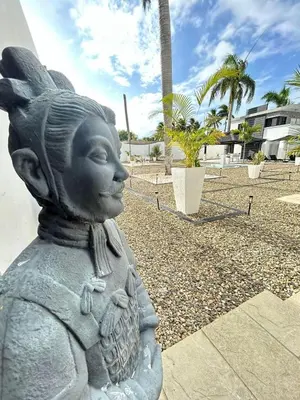 a statue of a little girl holding a basket at LEVEL suites in Sosúa