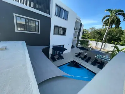 a house with a ramp next to a swimming pool at LEVEL suites in Sosúa