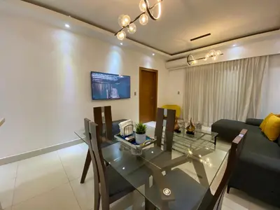 a living room with a glass table and a couch at Maravilloso Descanso in Santo Domingo