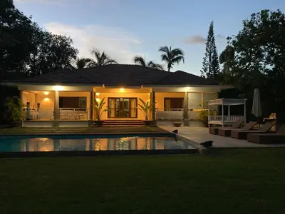 a house with a swimming pool in front of it at Villa Bali in Paraíso