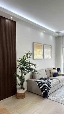 a living room with a couch and a plant at Relax in Style at Hard Rock Hotel Punta Cana Apartment in Punta Cana