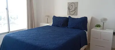 a bedroom with a blue bed and a window at Apartamento en Boca Chica T2 707 in Boca Chica