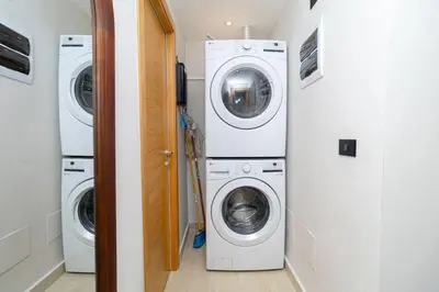 a laundry room with three washing machines and a washer and dryer at Tropical 1BR Getaway in Dominicus Bayahibe - Garden Breeze