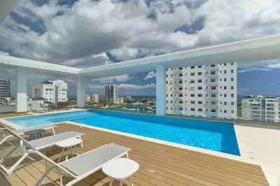 a large swimming pool on the roof of a building at Comfy Apt, Rooftop Lounge, Pool in Santo Domingo