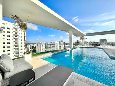a swimming pool on the roof of a building at Comfy Apt, Rooftop Lounge, Pool in Santo Domingo