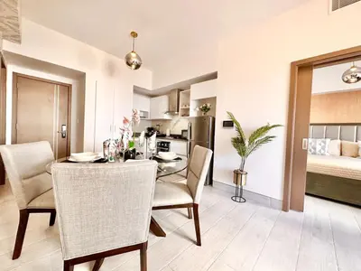 a kitchen and dining room with a table and chairs at Comfy Apt, Rooftop Lounge, Pool in Santo Domingo