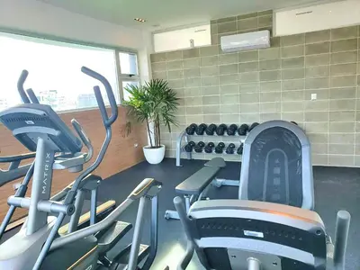 a gym with treadmills and exercise bikes in it at Comfy 1BR Apt, Centric Full AC in Santo Domingo