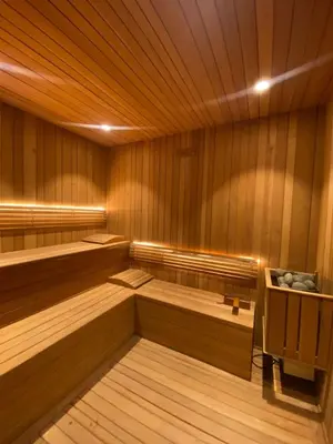 a sauna with wood paneling and benches in a room at Luxury Upscale Centric Condo, in Santo Domingo