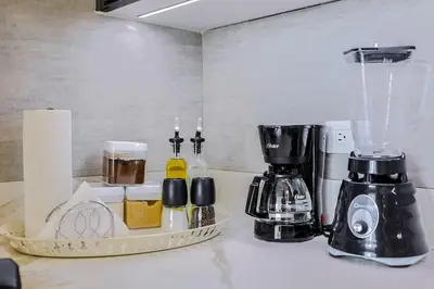 a kitchen counter with a coffee maker and a blender at Luxury Upscale Centric Condo, in Santo Domingo