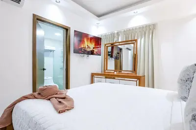 a bedroom with a white bed with a bow on it at Spacious, 3BD City Center Apt in Santo Domingo