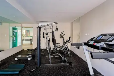 a gym with cardio equipment in a room at Spacious, 3BD City Center Apt in Santo Domingo