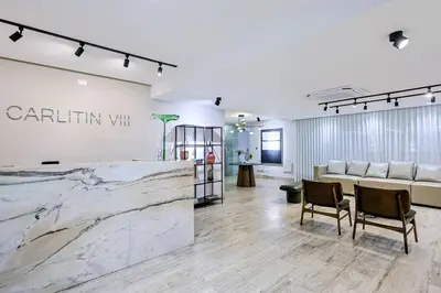 a lobby with a marble counter and chairs at Spacious, 3BD City Center Apt in Santo Domingo