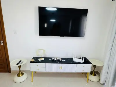 a room with two chairs and a tv on a wall at Welcome Home 2 in Boca Canasta