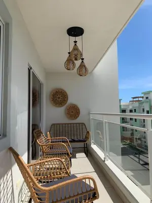 a balcony with two chairs and a couch on a balcony at Welcome Home 2 in Boca Canasta