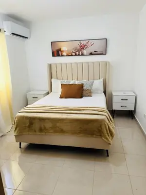 a bedroom with a large bed and two night stands at Welcome Home 2 in Boca Canasta