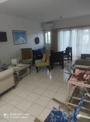 a living room with couches and chairs at Sweet beach apartment in San Felipe de Puerto Plata