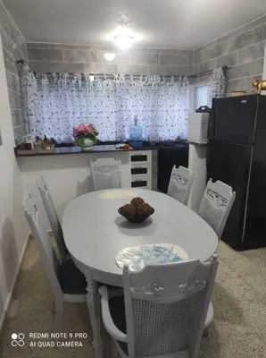 a small kitchen with a white table and chairs at Sweet beach apartment in San Felipe de Puerto Plata