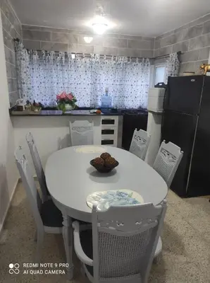a small kitchen with a white table and chairs at Sweet beach apartment in San Felipe de Puerto Plata